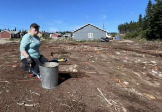 A woman digging at a site