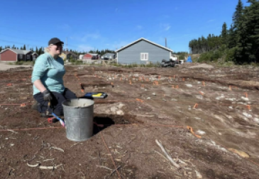 A woman digging at a site