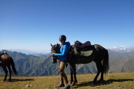 Presenter with a horse in the mountains