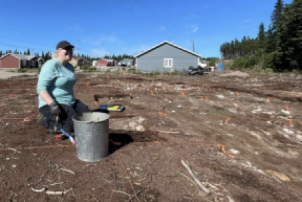 A woman digging at a site